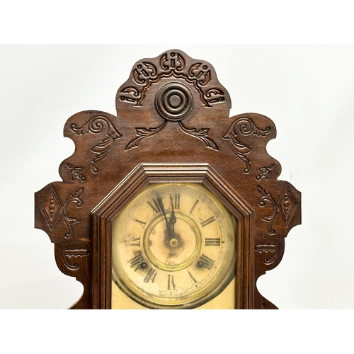 435 - A Late 19th Century American Gingerbread clock. With pendulum. 36x12x57cm.