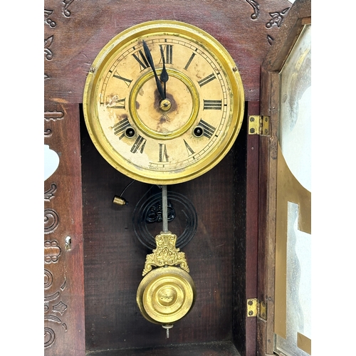 435 - A Late 19th Century American Gingerbread clock. With pendulum. 36x12x57cm.