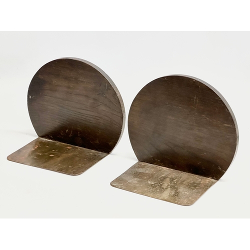 32 - A pair of Late 19th/ Early 20th Century bookends with embossed dragon leather panels in oak frames a... 