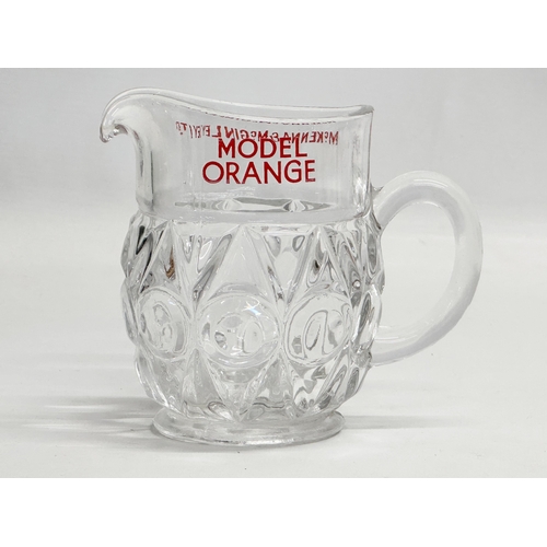 409 - A McKenna & McGinley LTD ‘Model Orange’ glass jug. 14x8x11cm.