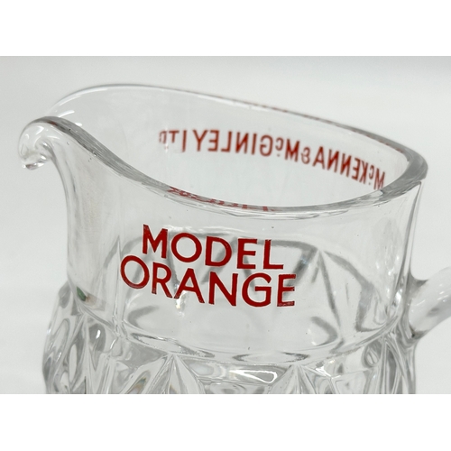 409 - A McKenna & McGinley LTD ‘Model Orange’ glass jug. 14x8x11cm.