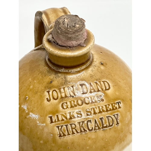 445 - A John Dand Kirkcaldy flagon. Grocer Links Street. 16x29cm.