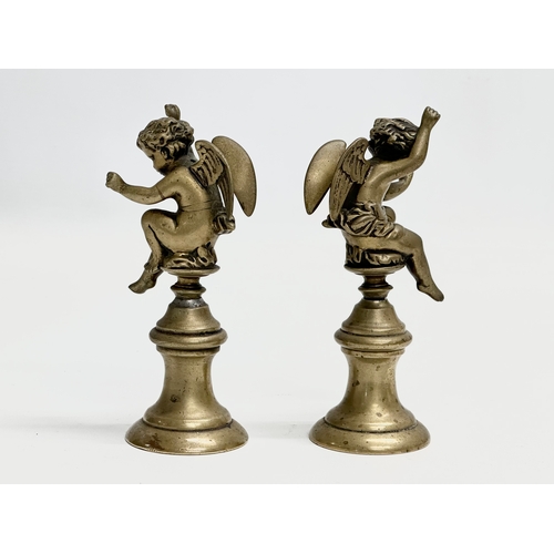 190 - A pair of Late 19th Century heavy brass cherubs. 14cm