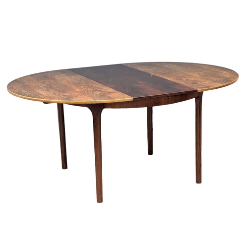 810 - A McIntosh Mid Century rosewood dining table and 4 chairs. Designed by Tom Robertson. (2)