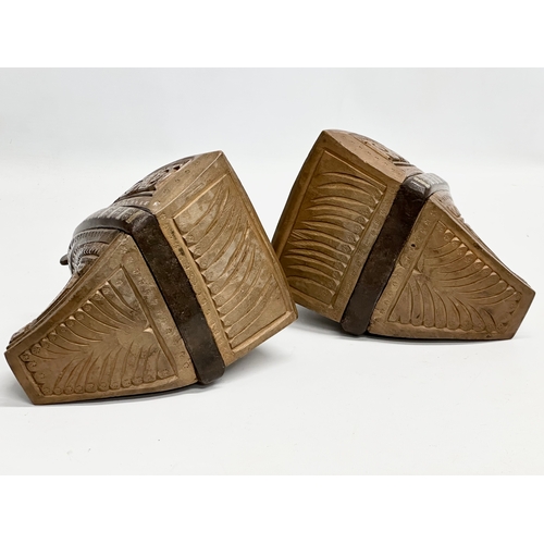 117 - A pair of 19th Century South American carved wooden stirrups with iron and silver metal mounts.