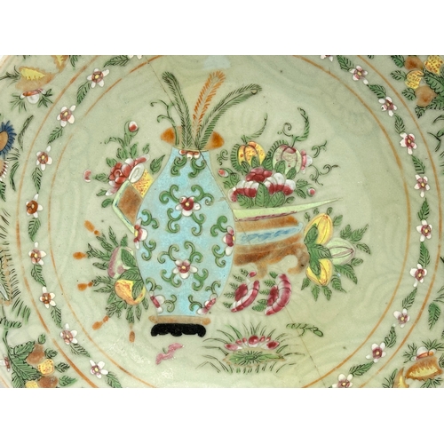 74 - A large 19th Century Chinese Famille Rose footed plate with a celadon glazed ground. Decorated with ... 