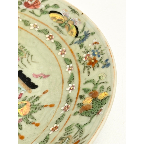 74 - A large 19th Century Chinese Famille Rose footed plate with a celadon glazed ground. Decorated with ... 