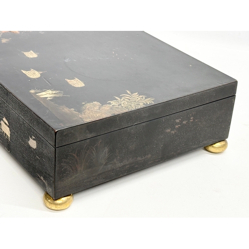 51 - A large Late 19th/Early 20th Century Japanese style hand painted lacquered jewellery box. Raised on ... 