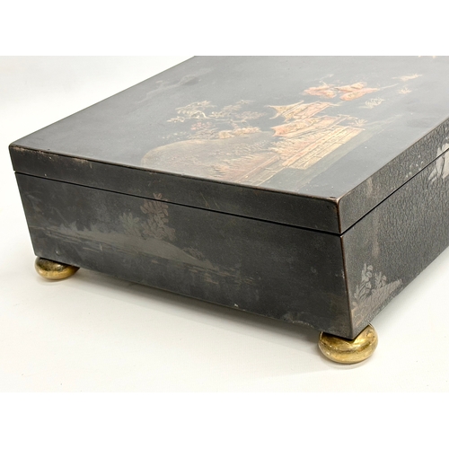 51 - A large Late 19th/Early 20th Century Japanese style hand painted lacquered jewellery box. Raised on ... 