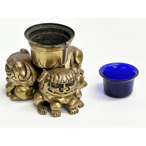 234 - A Late 19th Century brass foo dog ink well with Bristol Blue liner. 11.5x8.5cm.