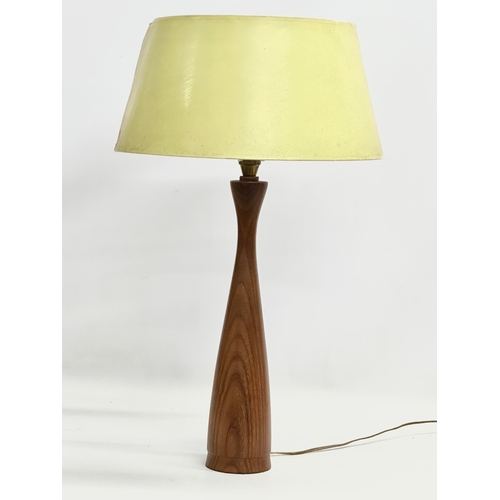 140 - A tall Mid Century teak table lamp. 60cm