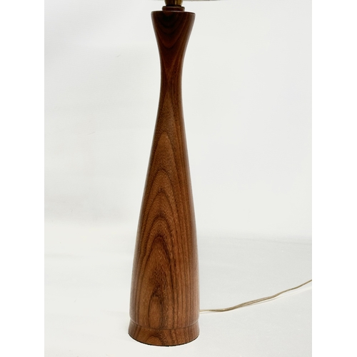 140 - A tall Mid Century teak table lamp. 60cm