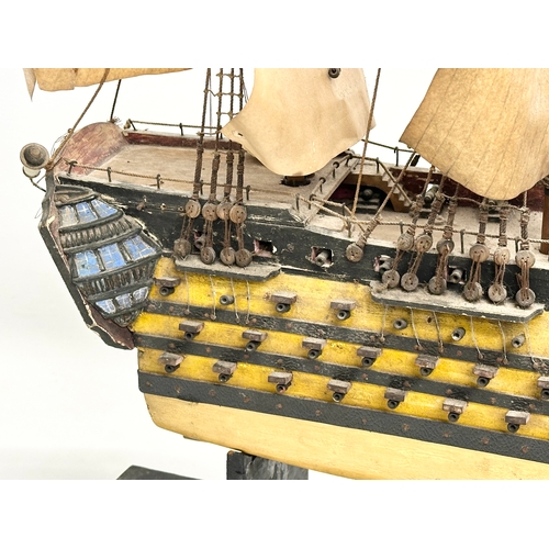 213 - A large Early 20th Century model of HMS Victory. Ship measures 65x71cm