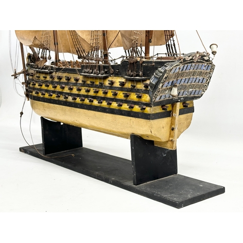 213 - A large Early 20th Century model of HMS Victory. Ship measures 65x71cm