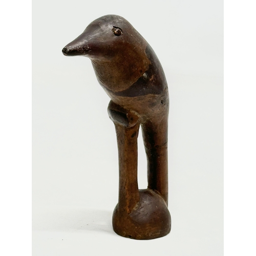 361 - A 19th Century carved wooden bird with lead filling. 15cm