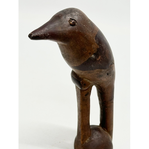 361 - A 19th Century carved wooden bird with lead filling. 15cm