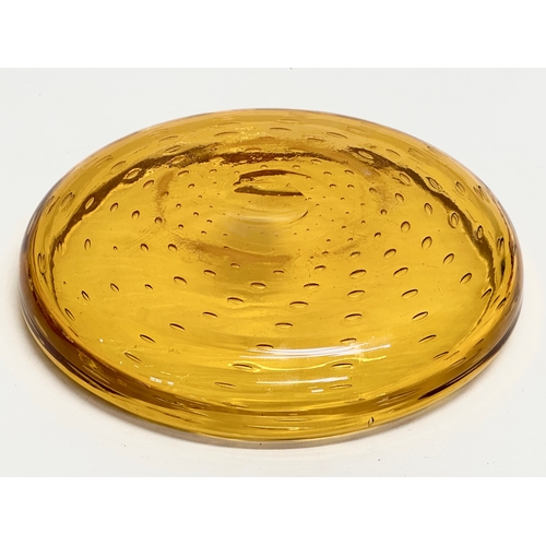 303 - A large controlled bubbles amber ass bowl designed by William Wilson for Whitefriars. 25x5cm.