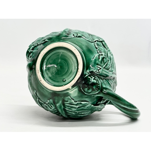 336 - A 20th Century cabbage teapot with Pegasus mark. In the manner of Dodie Thayer. 20x11x14cm