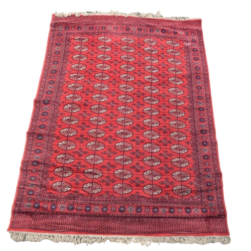 A large vintage Middle Eastern style rug. 199x310cm