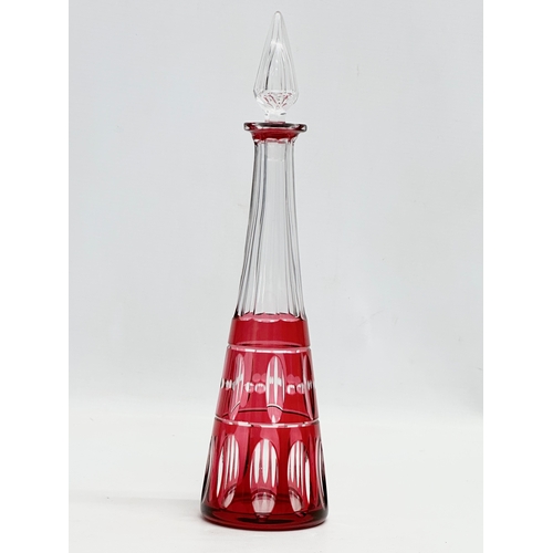 337 - Val Saint Lambert. A tall cranberry lens cut glass decanter by Val Saint Lambert. 1930/1940. 32cm.