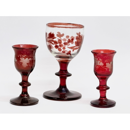 345 - Three 19th Century Bohemian ruby cordial glasses. 9.5cm. 7cm.