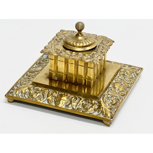 384 - A Late 19th/Early 20th Century brass inkwell. 13x13x8cm.