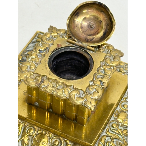 384 - A Late 19th/Early 20th Century brass inkwell. 13x13x8cm.