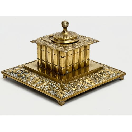 384 - A Late 19th/Early 20th Century brass inkwell. 13x13x8cm.