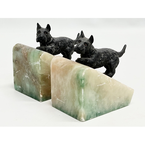 369 - A pair of Early 20th century onyx bookends with  speltre Scottie dogs. 11x8x12cm.