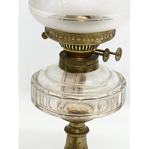 254 - A Late 19th Century Victorian double burner oil lamp. With later shade. 54cm