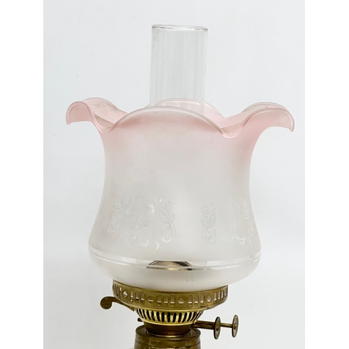 254 - A Late 19th Century Victorian double burner oil lamp. With later shade. 54cm