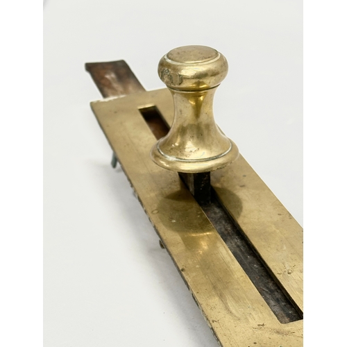 320 - A Victorian brass door bolt. 41cm