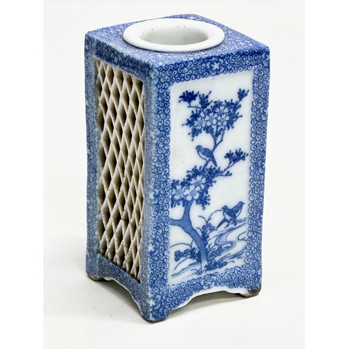 246C - An Early 20th Century Japanese blue and white pierced pottery vase. 11cm