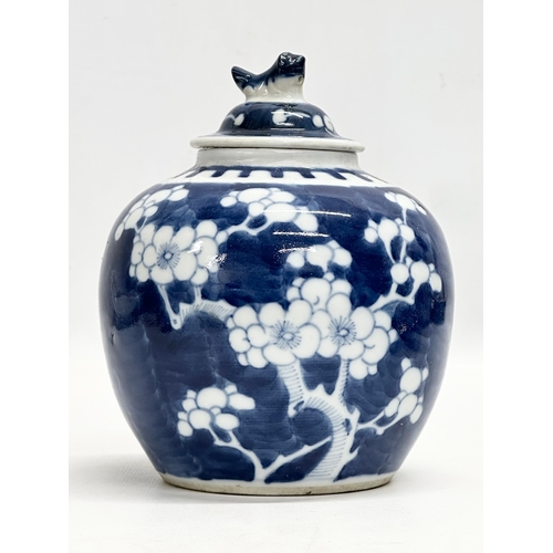 246D - A Late 19th Century Chinese blue and white prunus jar with cover. 12x16cm.