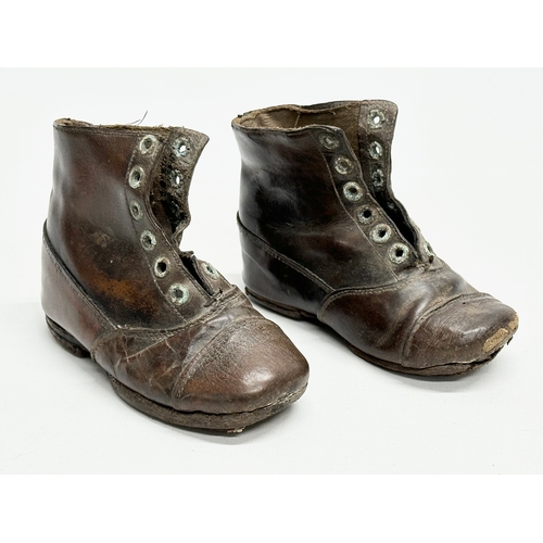 375 - A pair of 19th Century Victorian leather child’s shoes.