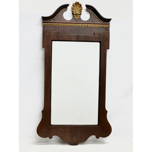 370B - An Early 20th Century George II style mahogany framed mirror. 57x107cm