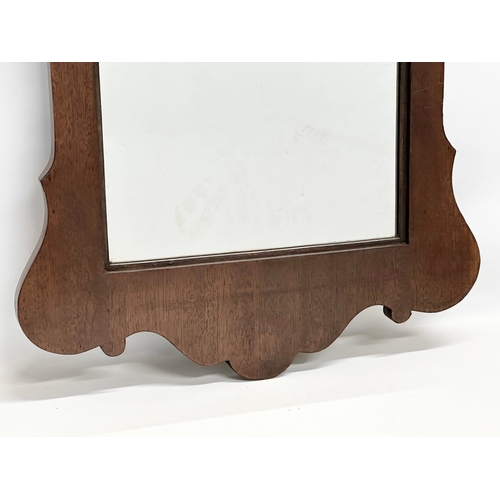 370B - An Early 20th Century George II style mahogany framed mirror. 57x107cm