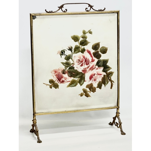 350N - An Edwardian period brass framed firescreen with painted bevelled glass. 47x22x68cm