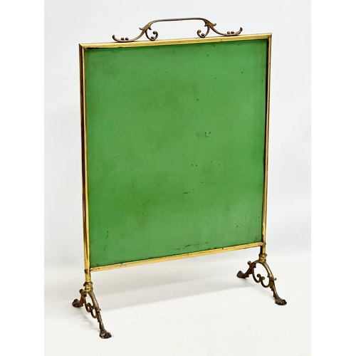 350N - An Edwardian period brass framed firescreen with painted bevelled glass. 47x22x68cm