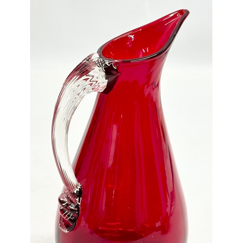 139 - Geoffrey Baxter. A Mid 20th Century ruby glass jug designed by Geoffrey Baxter for Whitefriars. 16.5... 