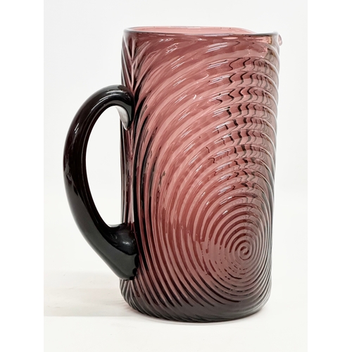 241 - A Mid/Late 20th Century amethyst swirl glass pitcher. 19x12x22cm.