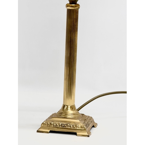 125 - A Tiffany style table lamp, with reeded brass column. 51cm