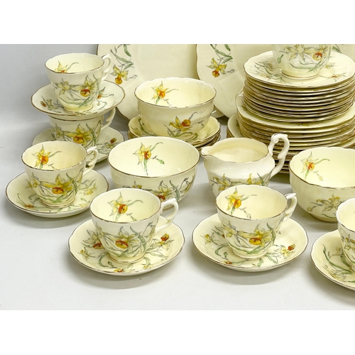 191 - A 64 piece Early 20th Century Crown Staffordshire ‘Daffodil’ tea service. 5 sugar bowls, 3 cream jug... 