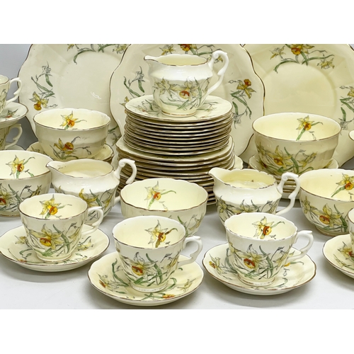 191 - A 64 piece Early 20th Century Crown Staffordshire ‘Daffodil’ tea service. 5 sugar bowls, 3 cream jug... 