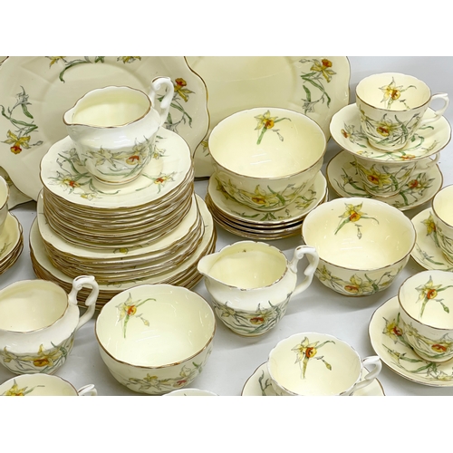 191 - A 64 piece Early 20th Century Crown Staffordshire ‘Daffodil’ tea service. 5 sugar bowls, 3 cream jug... 