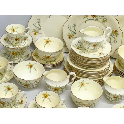 191 - A 64 piece Early 20th Century Crown Staffordshire ‘Daffodil’ tea service. 5 sugar bowls, 3 cream jug... 