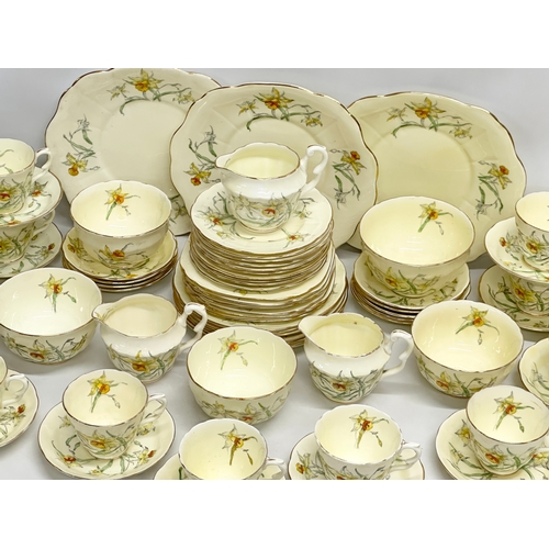 191 - A 64 piece Early 20th Century Crown Staffordshire ‘Daffodil’ tea service. 5 sugar bowls, 3 cream jug... 