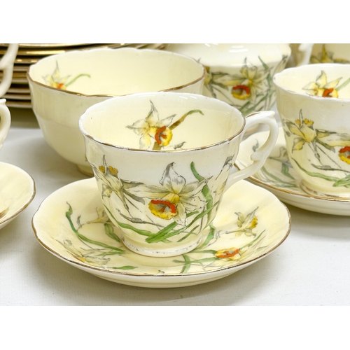 191 - A 64 piece Early 20th Century Crown Staffordshire ‘Daffodil’ tea service. 5 sugar bowls, 3 cream jug... 