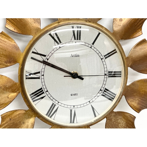 212 - A Mid Century brass framed sunburst clock by Acctim. 33cm