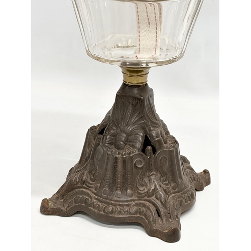 199 - A Late 19th Century Victorian double burner oil lamp, with slice cut glass bowl and cast iron base. ... 